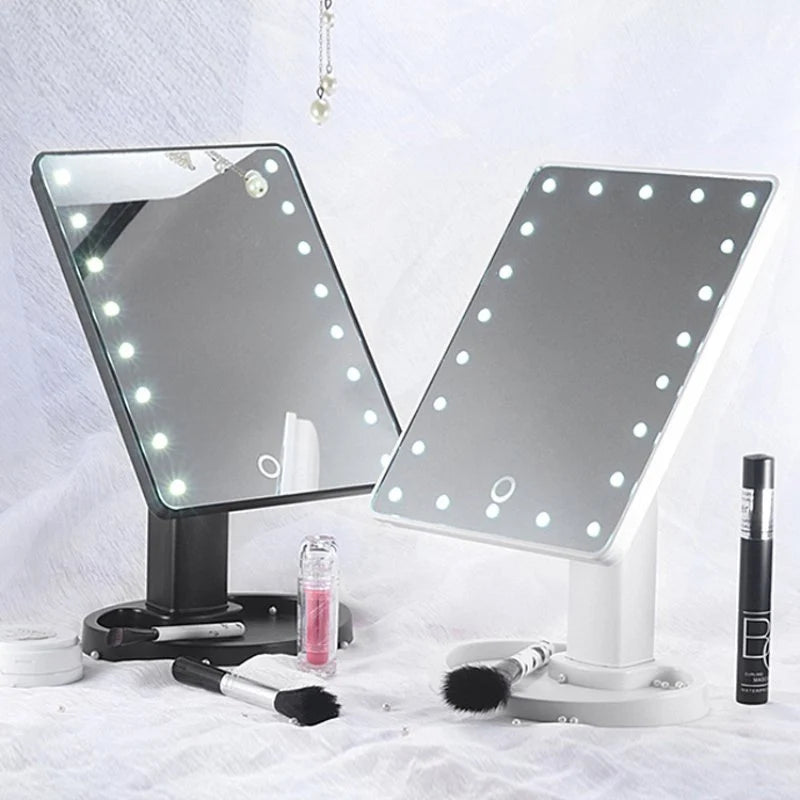 Two vanity mirrors with LED lights on a white background, surrounded by makeup products.