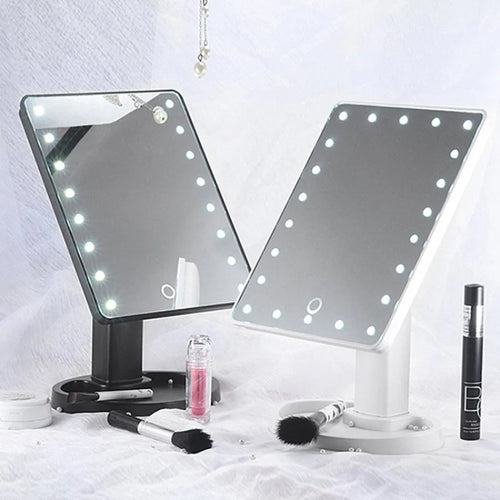 Two vanity mirrors with LED lights on a white background, surrounded by makeup products.
