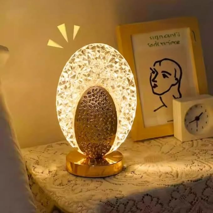Decorative table lamp with crystal design on a bedside table.